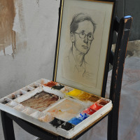 Paint palette and drawing for character reference in the painting. 