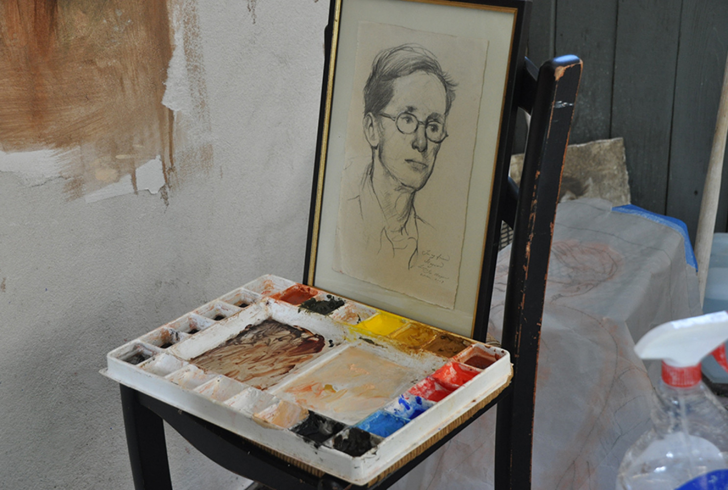 Paint palette and drawing for character reference in the painting. 