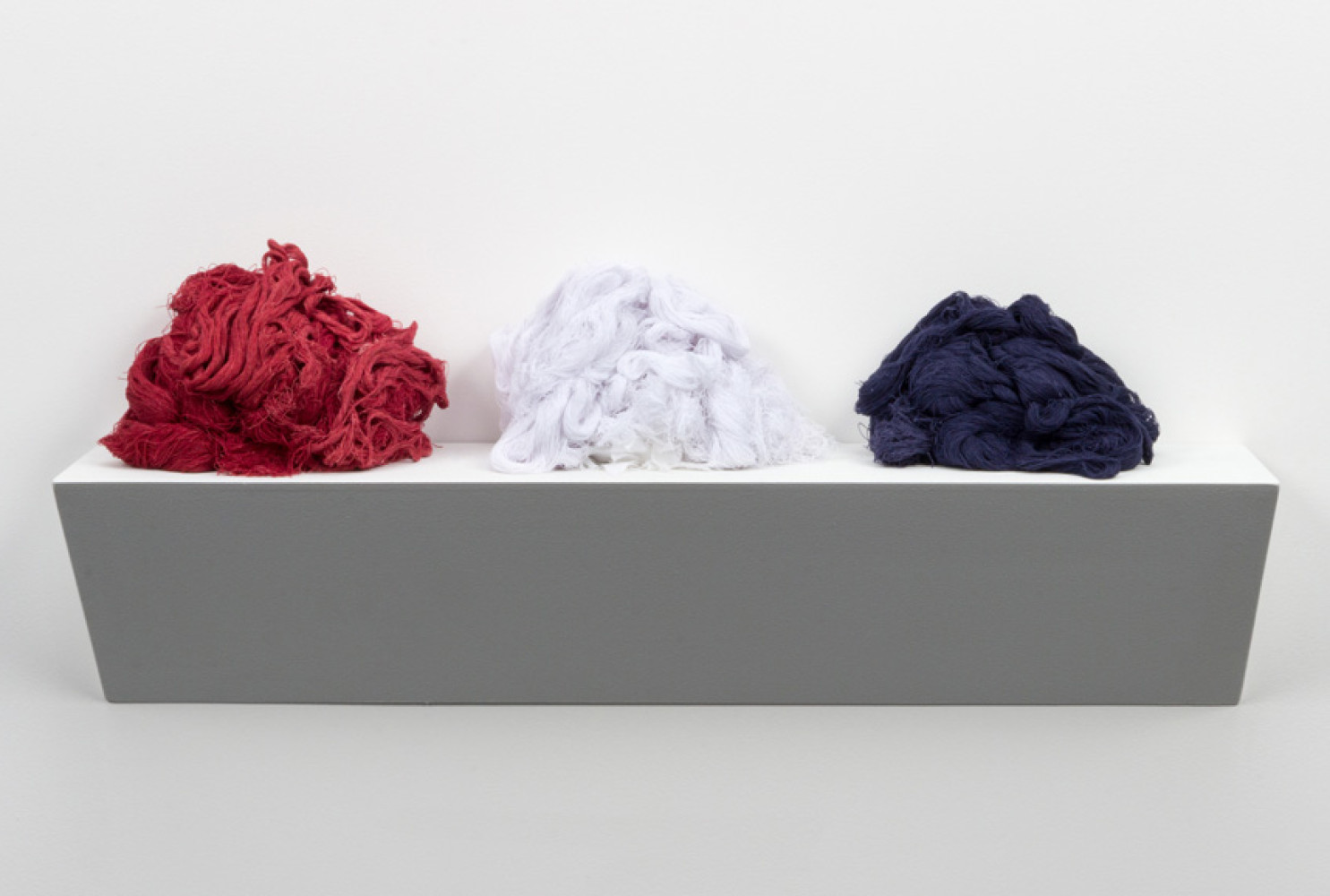 Unraveled, 2015, by Sonya Clark (American, b. 1967); unraveled cotton Confederate battle flag; 11 x 36 x 7 inches; Courtesy of the artist