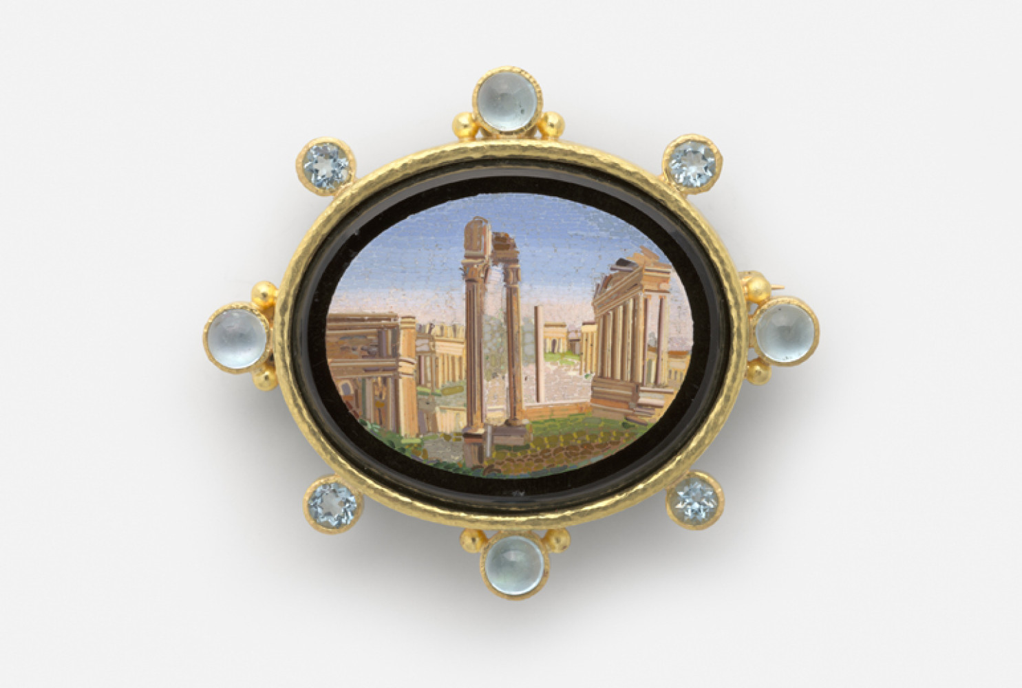 Roman Forum, Rome, 19th century; Micromosaic set in gold as a brooch, with alternating 6-mm cabochon aquamarines with side gold dots and 5-mm faceted aquamarines around bezel, 54 x 62 mm. Collection of Elizabeth Locke; Photo: Travis Fullerton; © Virginia Museum of Fine Arts

