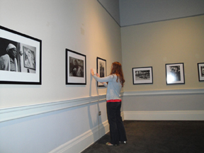 Laura Reece hanging labels in the Daufuskie Island exhibition