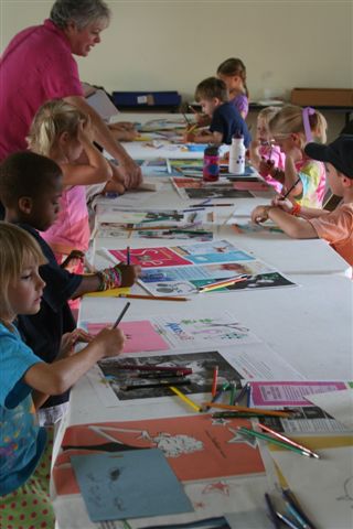 Sally Collins, art educator, works with campers to create their own works of art.