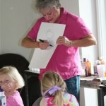 Sally Collins demonstrates a drawing technique with the campers.