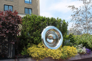 A mirrored sculpture installed on a private rooftop garden in downtown Chicago.