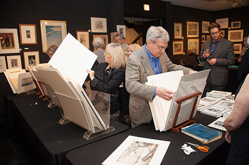 Guests at the First Look Celebration perused the works of art for sale.