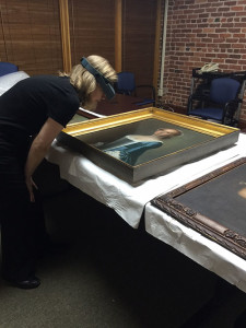 Shelley reviewing Jeremiah Theus paintings from the Gibbes permanent collection