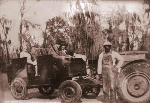 Big Survey Plantation. Seated, L to R: Irene Guggenheim, an unknown gentleman, and McNeil's grandmother Barbara. Standing: Samuel Terry, who still works at the plantation today at the age of 97.