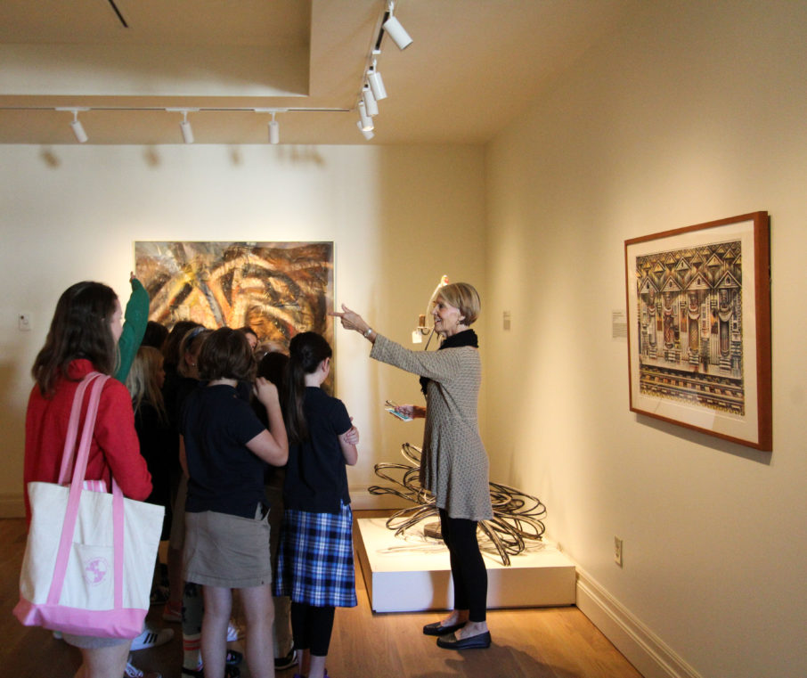 A Museum Educator leads a school group through the third-floor galleries.
