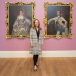 Woman standing in front of 2 paintings