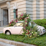 Pink car covered with flowers in front of the Gibbes