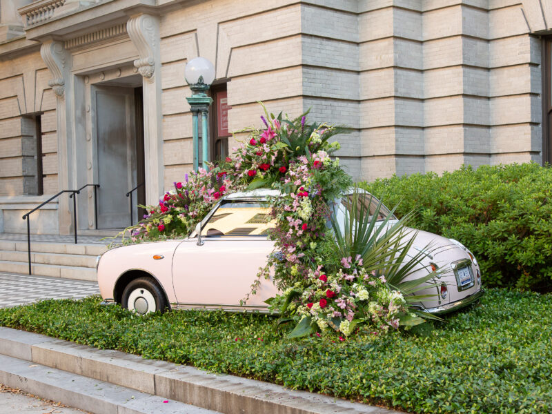 Pink car covered with flowers in front of the Gibbes